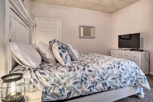 a bedroom with a bed with pillows and a tv at Hiawassee Cabin with Mtn Views Less Than 1 Mi to Lake! in Hiawassee