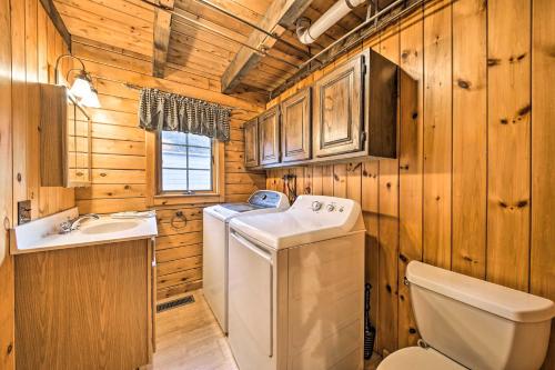 a washer and dryer in a bathroom with wooden walls at All-Season Sanctuary Steps to Moosehead Lake in Greenville