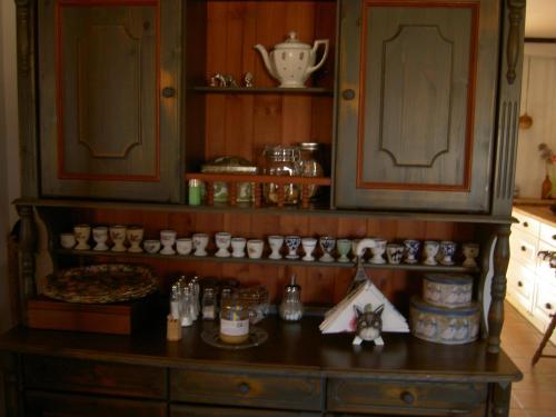a kitchen counter with a bunch of cups on it at Stakaberg Konferens & Gårdshotell in Halmstad