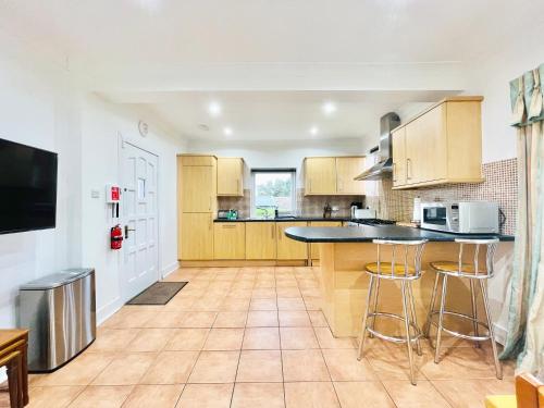 a kitchen with wooden cabinets and a counter top at Millerston House in Glasgow