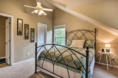 ein Schlafzimmer mit einem Bett und einem Deckenventilator in der Unterkunft Lakefront Camdenton Home with Fire Pit and Grill! in Camdenton