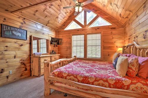 a bedroom with a bed in a wooden cabin at Woodsy Retreat with Hot Tub, 8 Mi to Dollywood! in Sevierville
