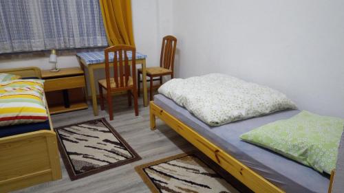 a bedroom with a bed and a table and a dining room at LINDENHOF WALDHEIM in Waldheim