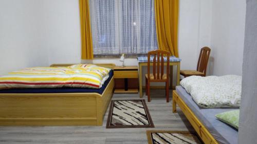 a bedroom with a desk and a bed and a table at LINDENHOF WALDHEIM in Waldheim