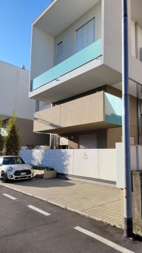 a car parked in a parking lot next to a building at Le Rondini in Barlassina