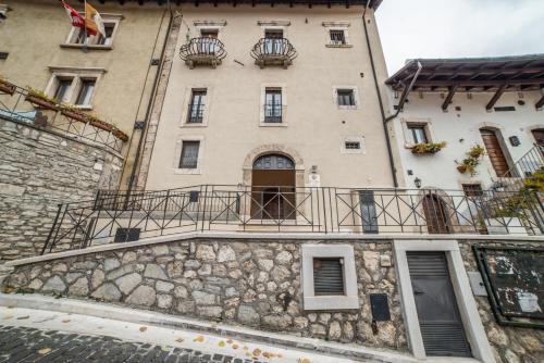 a building with balconies on the side of it at Dimora Fresilia Casa Vacanze in Opi