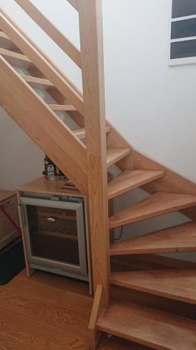 a wooden stairs with a television underneath it at Vučko Apartman U532 in Jahorina