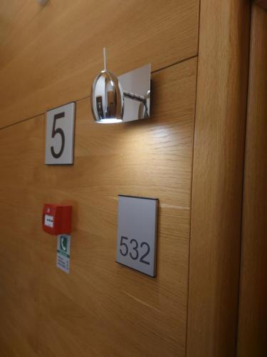 a wooden door with numbers and a light on it at Vučko Apartman U532 in Jahorina