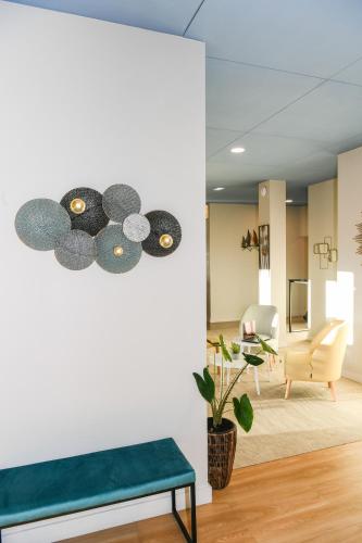 a living room with a green bench and a white wall at Best Western Plus Le Havre Centre Gare in Le Havre