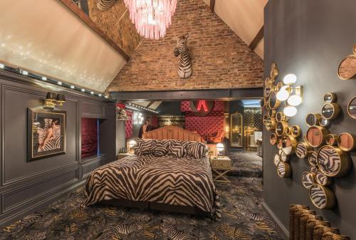 a zebra themed bedroom with a bed and a chandelier at The Impeccable Pig in Sedgefield