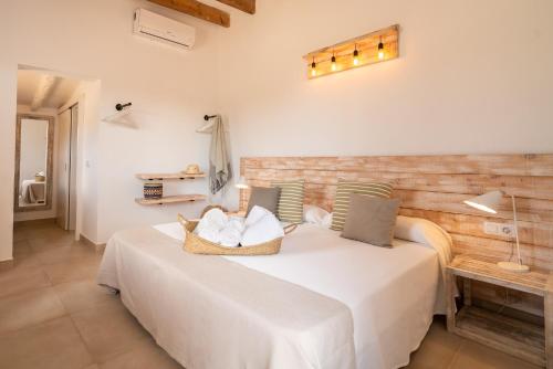 a bedroom with a bed with a basket on it at Cas Saliners - Ses Illetes in La Savina