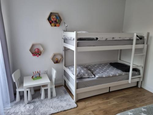 a bedroom with two bunk beds and a table at VIP apartmán in Rajecké Teplice
