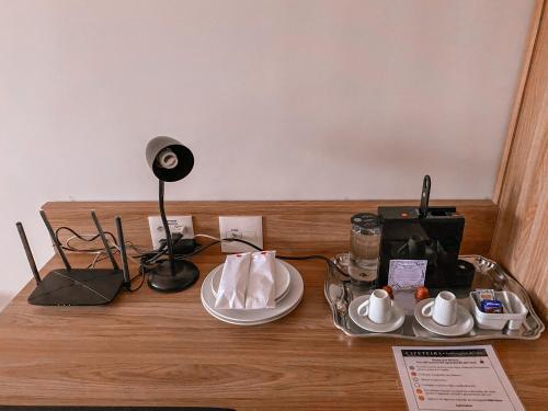 a table with a plate of food and a lamp at Apart-hotel Granja Brasil Itaipava in Itaipava