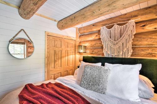 a bedroom with a bed and a wooden wall at Remodeled Fairplay Log Cabin with Wood-Burning Sauna in Fairplay