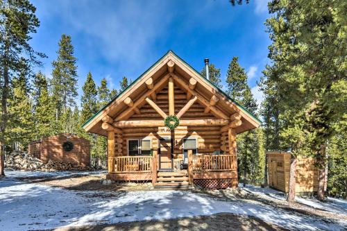 a log cabin in the woods in the snow at Remodeled Fairplay Log Cabin with Wood-Burning Sauna in Fairplay