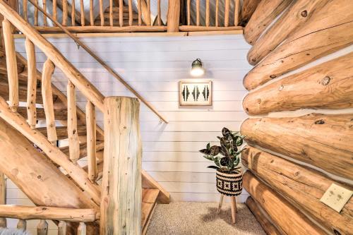 a staircase in a log cabin with a potted plant at Remodeled Fairplay Log Cabin with Wood-Burning Sauna in Fairplay