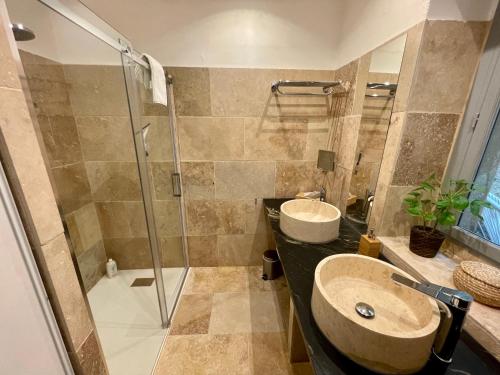 ein Badezimmer mit zwei Waschbecken und einer Dusche in der Unterkunft Maison de Roche-Uzès Centre Historique L' Ucetia in Uzès