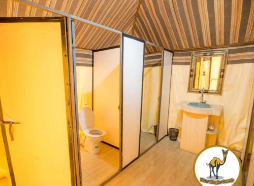 a room with a bathroom with a toilet and a mirror at Your magic camp in Merzouga