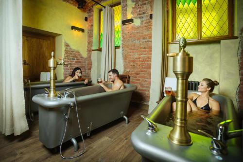 a group of people sitting in a bath tub at Letna Garden Suites in Prague