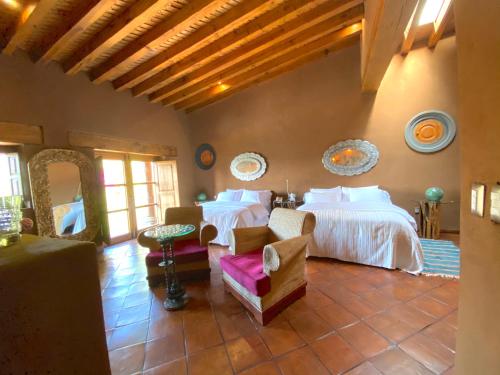 a bedroom with two beds in a room at Hacienda Ucazanaztacua in Pátzcuaro