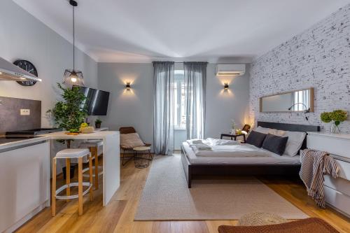 a living room with a bed and a kitchen at Adria Square Studios in Rijeka