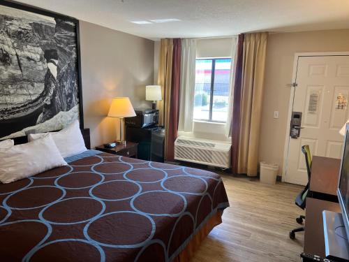 A bed or beds in a room at Super 8 by Wyndham Tucson/Grant Road Area AZ