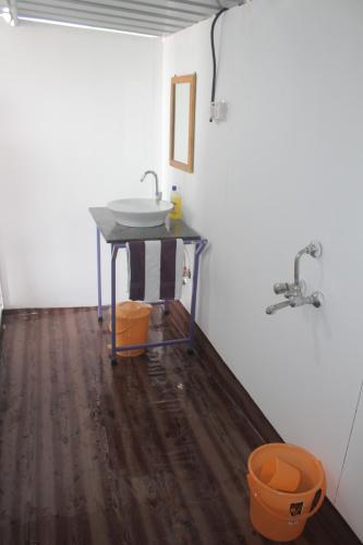 a bathroom with a sink and a sink at Arya Cottages in Agonda