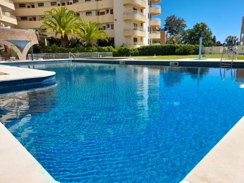 a large blue swimming pool in front of a building at Marina Mar 'Penthouse' by SAPvillas in Vilamoura