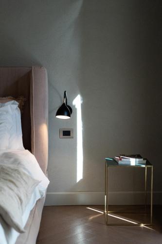 a bedroom with a bed and a table with a lamp at InCanto in Palermo