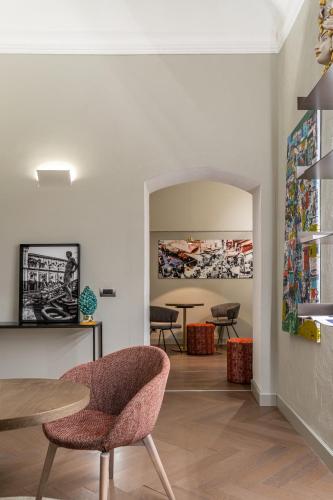 a dining room with a table and chairs and a table at InCanto in Palermo