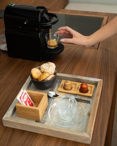 a person is making a drink in a coffee maker at InCanto in Palermo