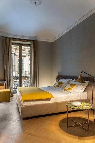 a bedroom with a large bed and a table at InCanto in Palermo
