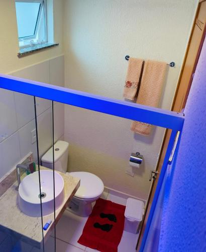 a small bathroom with a toilet and a sink at Casa da Dinda in Ilhéus