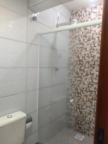 a bathroom with a glass shower with a toilet at Apto Boss Campos in Campos dos Goytacazes