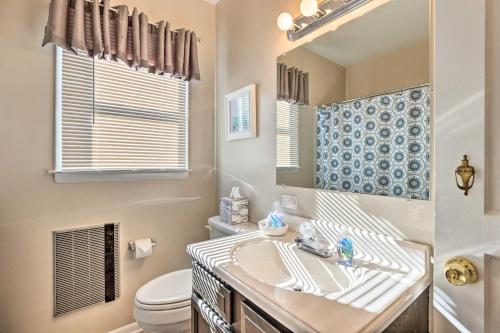 a bathroom with a sink and a toilet and a mirror at Colonial Beach House with Patio 2 Blocks to Beach! in Colonial Beach