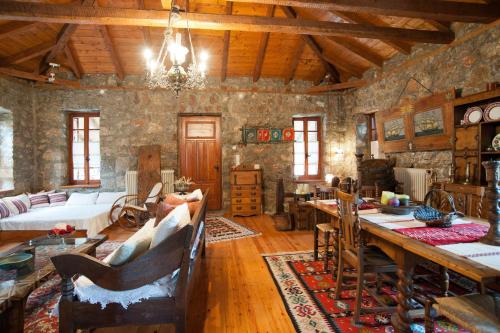 una sala de estar con mesa en un edificio de piedra en MARIOLATA STONE HOUSE en Lílaia