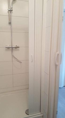 a bathroom with a shower with a glass door at Pension Italia in Lübeck