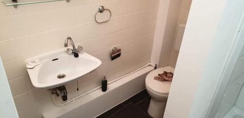 a bathroom with a sink and a toilet at Pension Italia in Lübeck