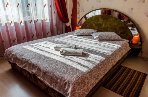 a bedroom with a bed with two towels on it at Pālena apartamenti in Tērvete