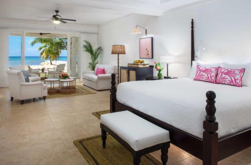 a bedroom with a bed and a living room at Half Moon in Montego Bay