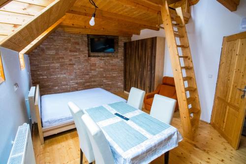 een kamer met een bed, een tafel en een ladder bij Statek U Kalinů in Nové Město na Moravě