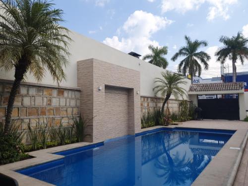 a large swimming pool in a residential area at Casa AMMAH in Ciudad Valles