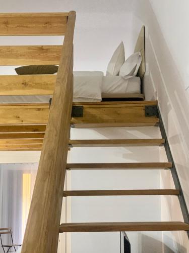 a bed on the stairs of a house at Puerta de Caceres Apartamento 3 in Cáceres