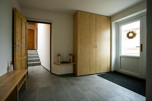 a hallway with wooden cabinets and a window at Statek U Kalinů in Nové Město na Moravě