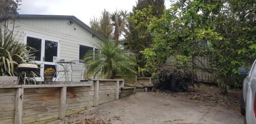 a backyard with a fence and a house at Affordable, Spacious, Bright, Warm, Unit in Central Whangarei in Whangarei