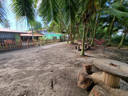 a wooden bench sitting on the side of a street at Caribbean View in Tortuguero