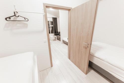 a room with a door leading to a bedroom at Aurora Cabins in Höfn