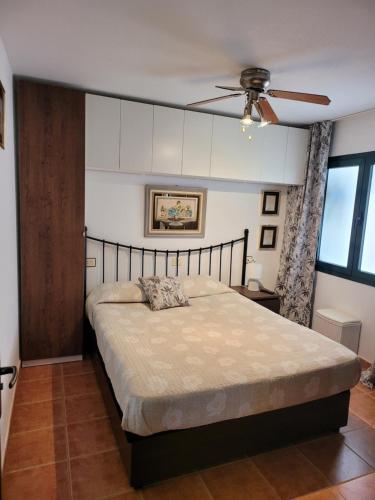 a bedroom with a bed and a ceiling fan at Appartamento Rosy Puerta del Sol in Caleta De Fuste