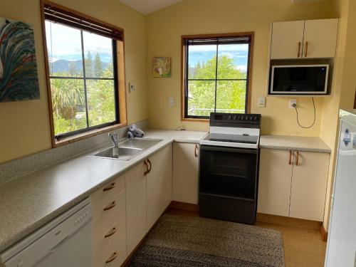 a kitchen with a sink and a stove at 30 St James Avenue in Hanmer Springs