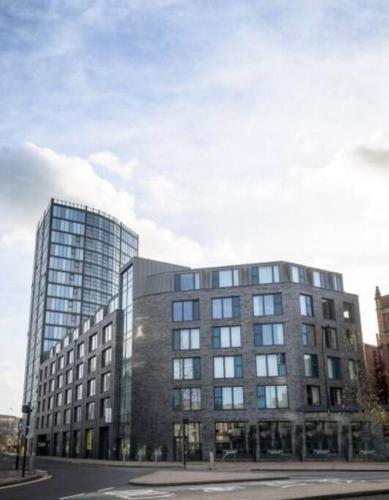 a large building with a lot of windows on a street at Spacious City Centre 2 bedroom apartment in Sheffield